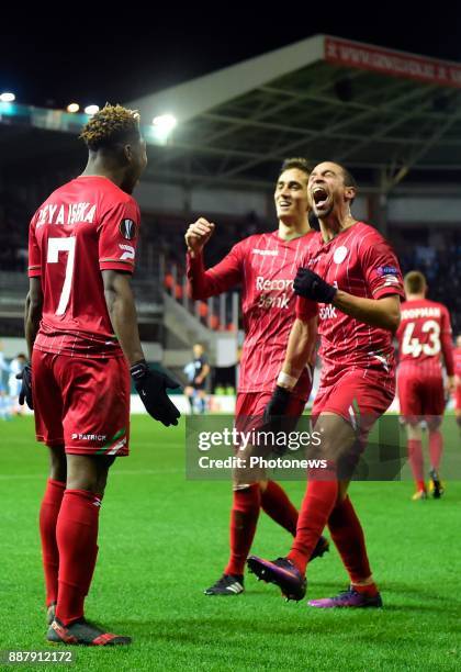 Aaron Leya Iseka forward of SV Zulte Waregem celebrates scoring a goal with teammates Nill De Pauw midfielder of SV Zulte Waregem and Julien De Sart...