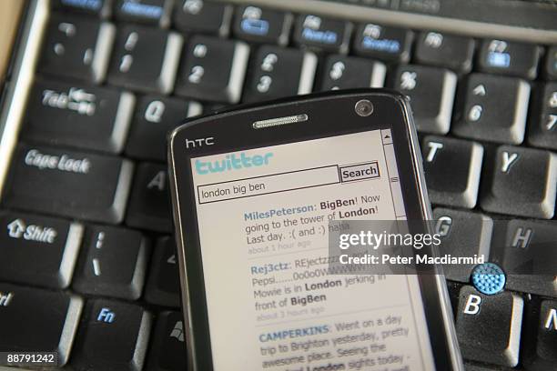 In this photo illustration the Twitter website is displayed on a mobile phone on July 2, 2009 in London. The social network site, started in 2006 in...