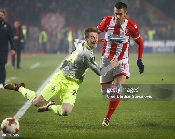 Lukas Klunter of FC Koeln is challenged by Aleksandar Pesic of Crvena Zvezda during the UEFA Europa League group H match between Crvena Zvezda and 1....