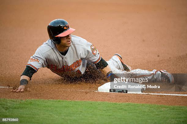 Brian Roberts of the Baltimore Orioles slides into third base during a MLB game against the Florida Marlins at LandShark Stadium on June 25, 2009 in...