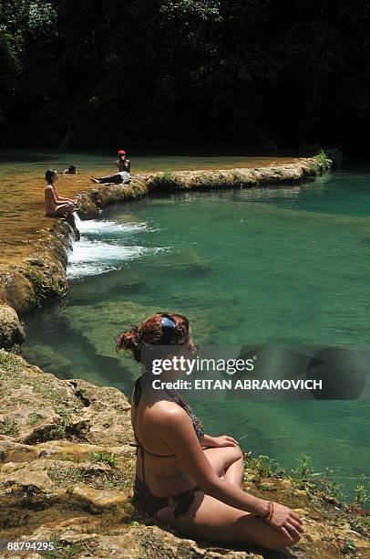 Tourists sunbathe in Semuc Champey National Park in the Guatemalan department of Alta Verapaz, on June 28, 2009. The Natural monument of Semuc...