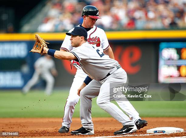 Mark Teixeira of the New York Yankees and Chipper Jones of the Atlanta Braves at Turner Field on June 25, 2009 in Atlanta, Georgia.