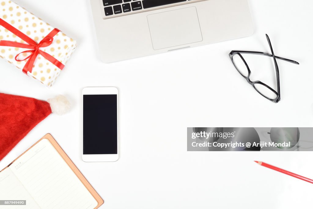 Top view computer and phone for business concept with Christmas festival theme, white background copy space