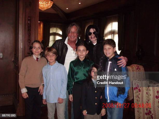 In this handout photo provided by Mohamed Hadid, singer Michael Jackson poses with real estate developer Mohamed Hadid , Hadid's children and...