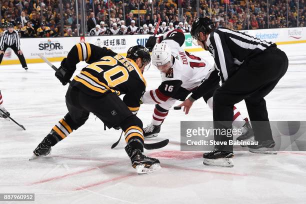 Riley Nash of the Boston Bruins faces off against Max Domi of the Arizona Coyotes at the TD Garden on December 7, 2017 in Boston, Massachusetts.