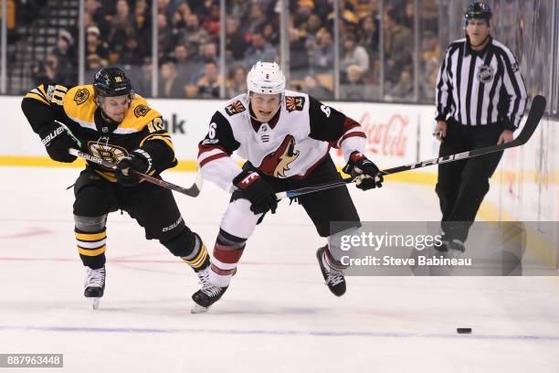 Jakob Chychrun of the Arizona Coyotes skates against Anders Bjork of the Boston Bruins at the TD Garden on December 7, 2017 in Boston, Massachusetts.