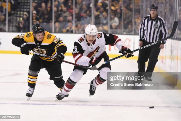 Jakob Chychrun of the Arizona Coyotes skates against Anders Bjork of the Boston Bruins at the TD Garden on December 7, 2017 in Boston, Massachusetts.