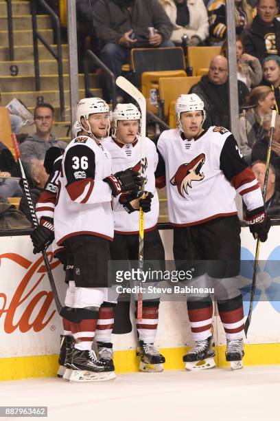Christian Fischer, Christian Dvorak and Luke Schenn of the Arizona Coyotes celebrate a goal in the first period against the Boston Bruins at the TD...