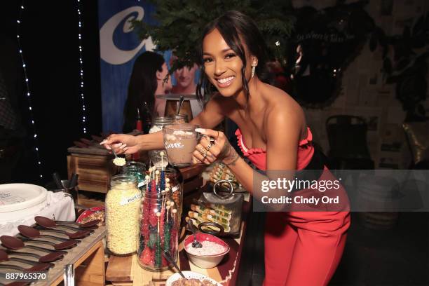 Actress & Model Karrueche Tran visits the hot chocolate bar as she hosts the Curve Fragrances Holiday Party at Arlo NoMad on December 7, 2017 in New...