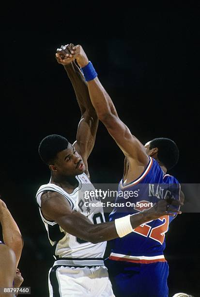 S: David Robinson of the San Antonio Spurs in action jumping center against Larry Nance of the Phoenix Suns during a late circa 1980's NBA basketball...