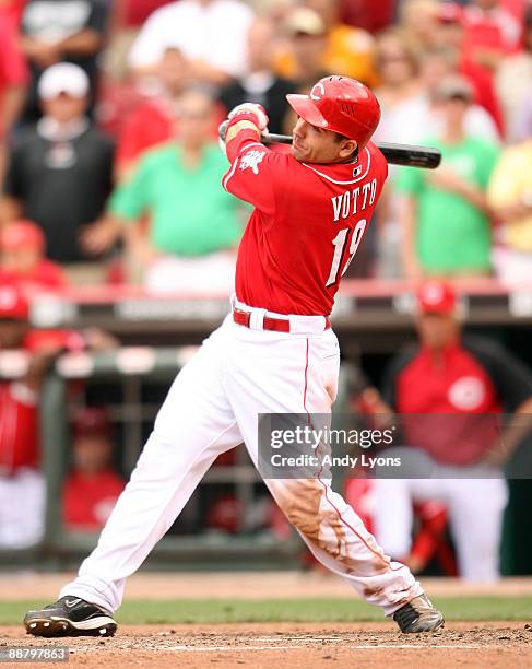 Joey Votto of the Cincinnati Reds hits a single to bring in the game winning run in the 10th inning during the game against the Arizona Diamondbacks...