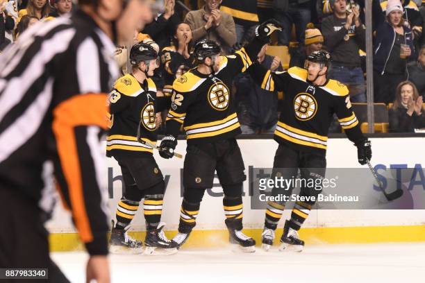 Danton Heinen, David Backes and Riley Nash of the Boston Bruins celebrate a goal in the second period against the Arizona Coyotes at the TD Garden on...