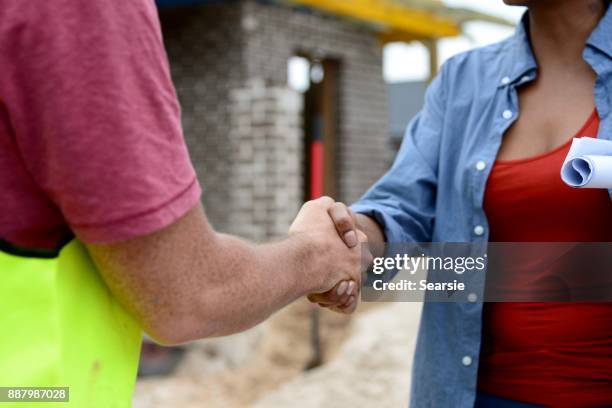 syd112017 diverse construction workers shaking hands - apprentice builder stock pictures, royalty-free photos & images