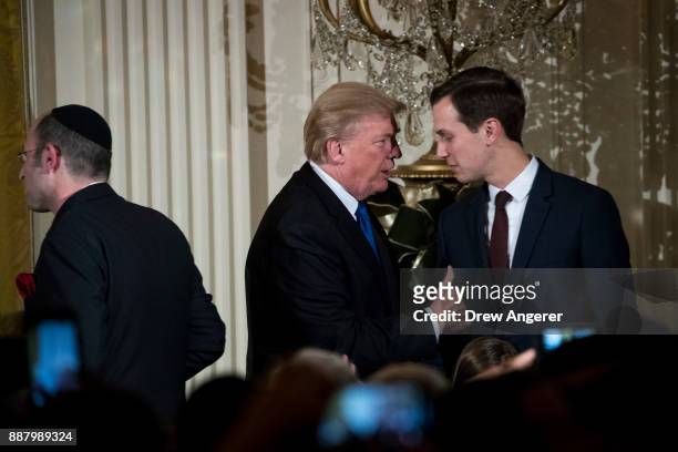 President Donald Trump talks with White House Senior Advisor to the President Jared Kushner as they attend a Hanukkah Reception in the East Room of...