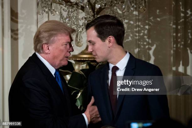 President Donald Trump talks with White House Senior Advisor to the President Jared Kushner as they attend a Hanukkah Reception in the East Room of...