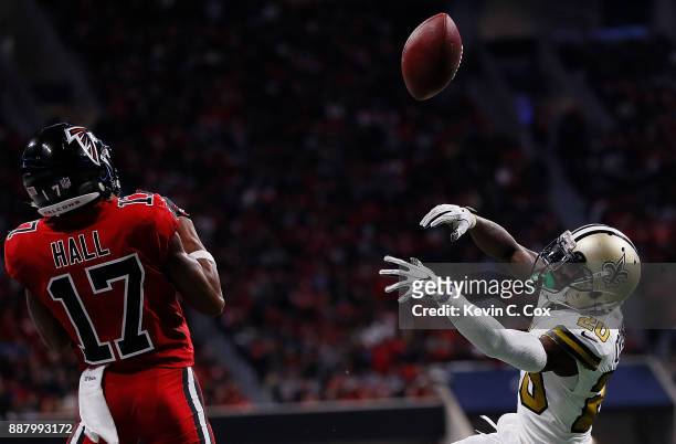 Ken Crawley of the New Orleans Saints breaks up a pass intended for Marvin Hall of the Atlanta Falcons at Mercedes-Benz Stadium on December 7, 2017...