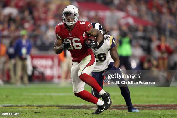 Tight end Ricky Seals-Jones of the Arizona Cardinals runs with the football after a reception ahead of inside linebacker Mark Barron of the Los...