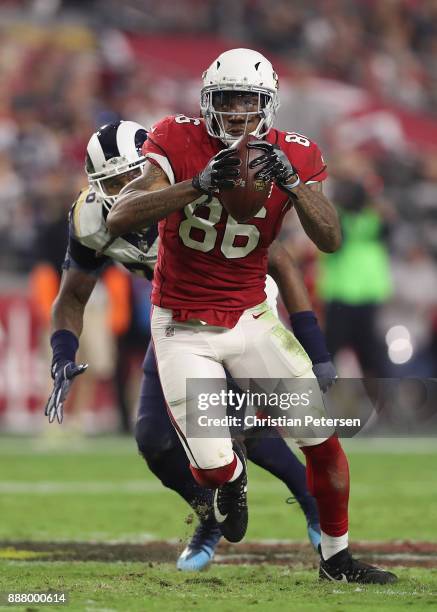 Tight end Ricky Seals-Jones of the Arizona Cardinals runs with the football after a reception ahead of inside linebacker Mark Barron of the Los...