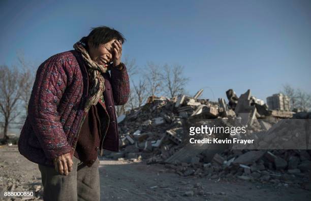 Chinese woman Zheng Yuzhi whose apartment was demolished by authorities three months ago and is now homeless, cries as she tells her story near...