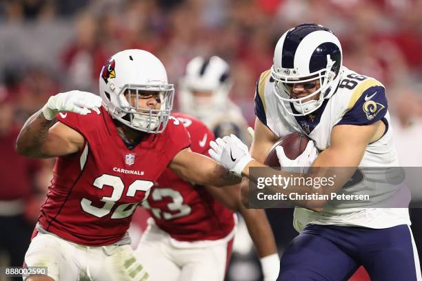 Tight end Derek Carrier of the Los Angeles Rams runs with the football after a reception against free safety Tyrann Mathieu of the Arizona Cardinals...