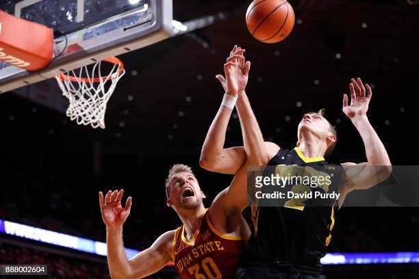 Hans Brase of the Iowa State Cyclones blocks a shot by Jack Nunge of the Iowa Hawkeyes in the second half of play at Hilton Coliseum on December 7,...