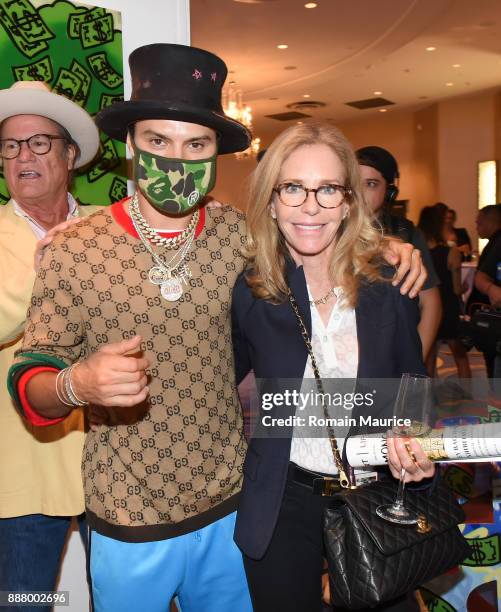 Alec Monopoly and Alexandra Andon attend Haute Living's VIP Pop-Up Opening Of Alec Monopoly From Art Life And David Yarrow From Maddox Gallery at...