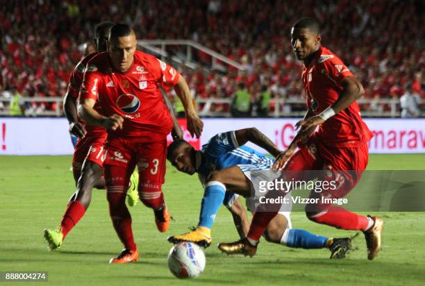 Harold Mosquera of Millonarios fights the ball with Juan Camilo Angulo of America de Cali during a match for the first leg semifinal of Liga Aguila...