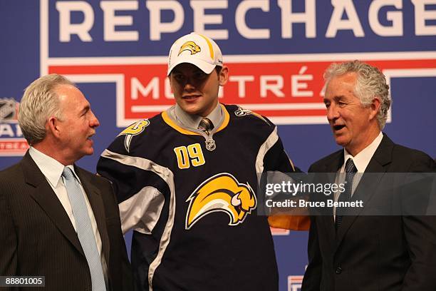 Zack Kassian poses with Buffalo Sabres Director of Amateur Scouting Kevin Devine and Amateur Scout Al MacAdam after being drafted during the first...