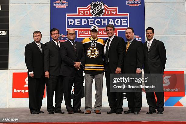 Jordan Caron poses with members of the Boston Bruins organization Director of Player Personnel Scott Bradley, Assistant GM Jim Benning, GM Peter...