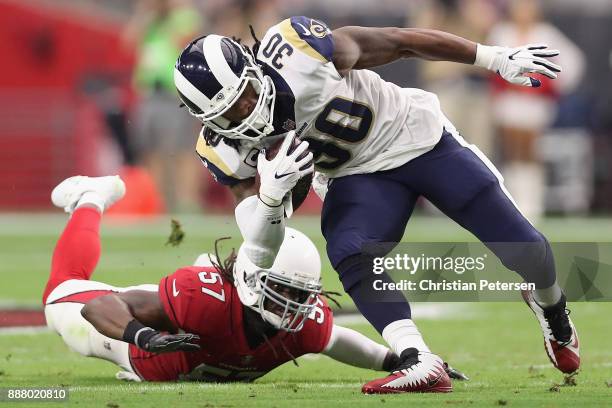 Running back Todd Gurley of the Los Angeles Rams rushes the football past linebacker Josh Bynes of the Arizona Cardinals during the NFL game at the...