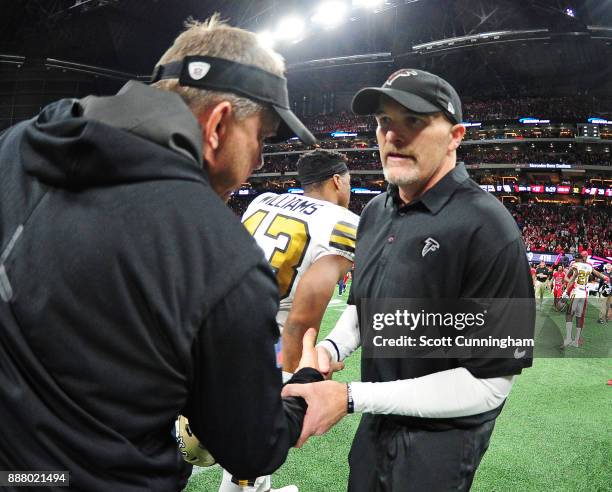 Head Coach Dan Quinn of the Atlanta Falcons is congratulated by Head Coach Sean Payton after the game against the New Orleans Saints at Mercedes-Benz...