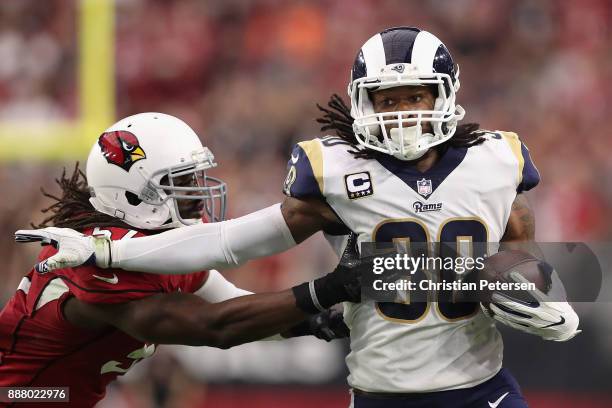 Running back Todd Gurley of the Los Angeles Rams rushes the football past linebacker Josh Bynes of the Arizona Cardinals during the NFL game at the...