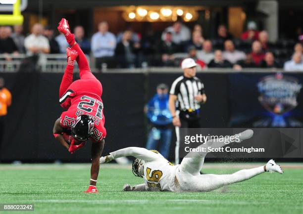 Mohamed Sanu of the Atlanta Falcons is upended by P. J. Williams of the New Orleans Saints at Mercedes-Benz Stadium on December 7, 2017 in Atlanta,...