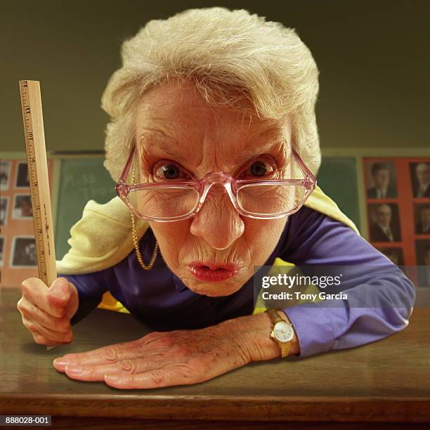 elderly teacher with glasses, holding ruler, close-up (composite) - aggression school stock pictures, royalty-free photos & images