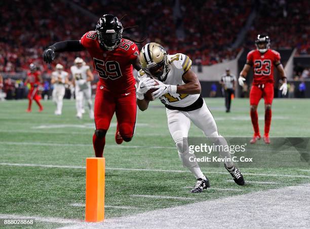 Tommylee Lewis of the New Orleans Saints prepares to dive for a touchdown before being tackled by De'Vondre Campbell of the Atlanta Falcons at...