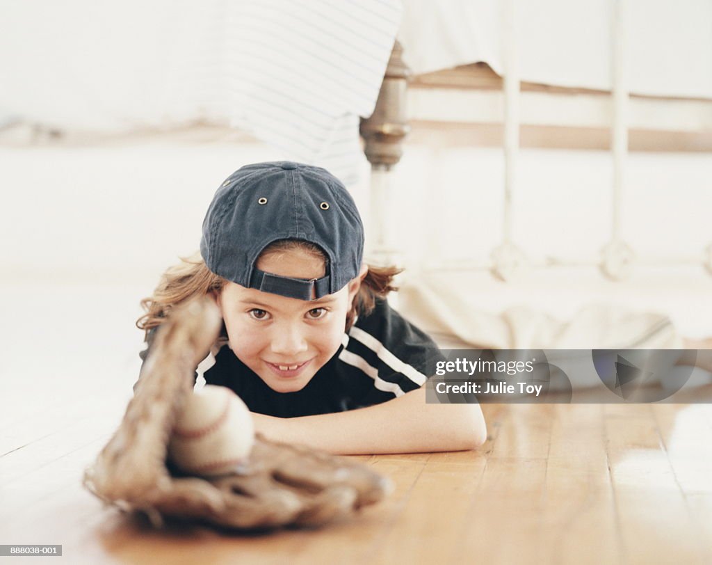 Young boy (6-8) in baseball outfit, portrait