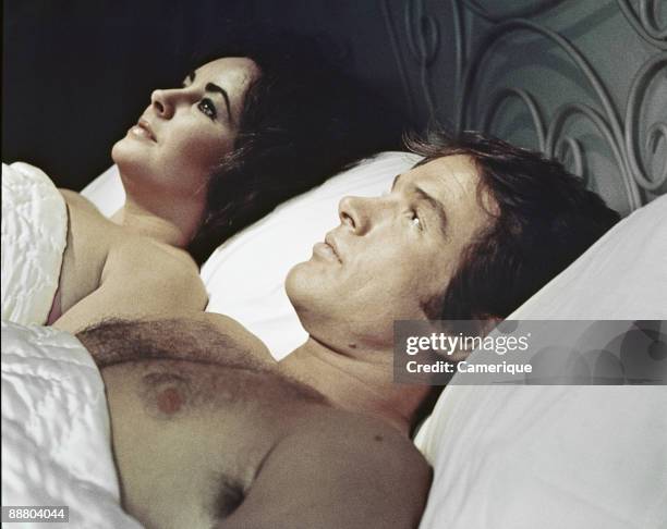 Scene showing Warren Beatty lying down next to Elizabeth Taylor, from the movie 'Only Game in Town', 1970.