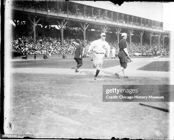 Image of Hall of Fame baseball player Frank Chance of the National League's Chicago Cubs, running past home plate on the field at West Side Grounds,...