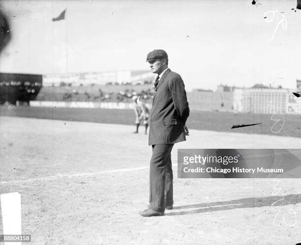 Informal full-length portrait of baseball umpire William 'The Boy Umpire' Evans standing in foul territory along the first baseline on the field at...