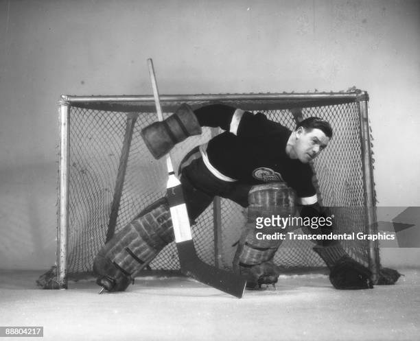Cecil Ralph 'Tiny' Thompson goalie for the Detroit Red Wings poses in the net, Detroit, MI, 1939.