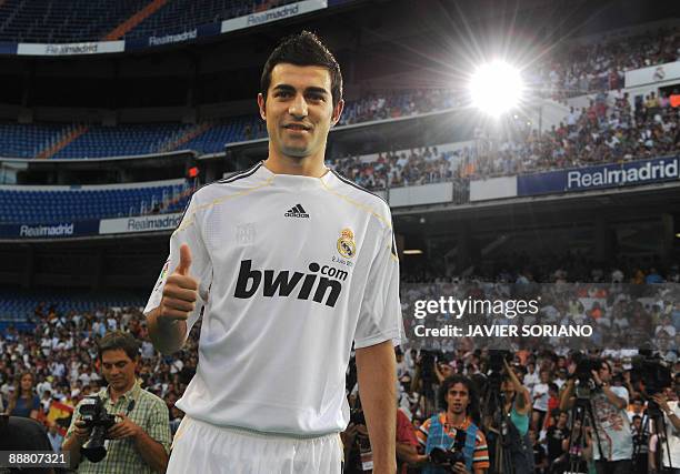 Real Madrid's new player Spanish defender Raul Albiol gives the thumb up during his presentation at the Santiago Bernabeu stadium in Madrid on July...