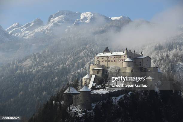 Hohenwerfen Castle stands on a crisp, winter morning under a mountain of the Berchtesgaden Alps among trees brushed with snow on December 7, 2017...