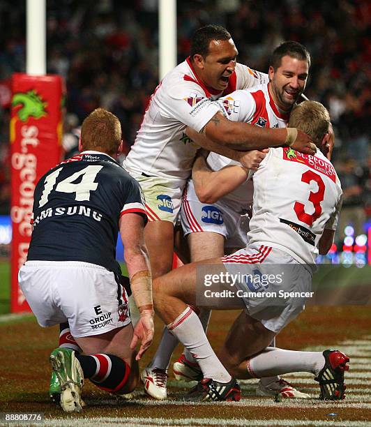 Matt Prior of the Dragons is congratulated by team mates after scoring a try during the round 17 NRL match between the St George Illawarra Dragons...