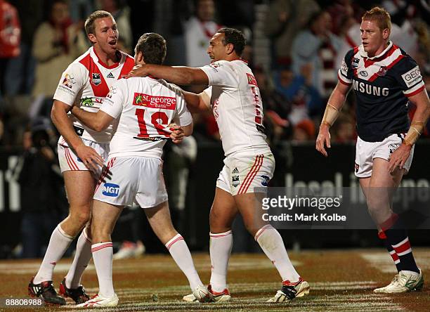 Matt Prior of the Dragons celebrates with his team mates after he scored a try during the round 17 NRL match between the St George Illawarra Dragons...