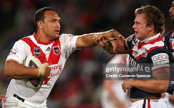 Neville Costigan of the Dragons pushes Jake Friend of the Roosters during the round 17 NRL match between the St George Illawarra Dragons and the...