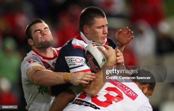 Shaun Kenny-Dowall of the Roosters is tackled during the round 17 NRL match between the St George Illawarra Dragons and the Sydney Roosters at WIN...