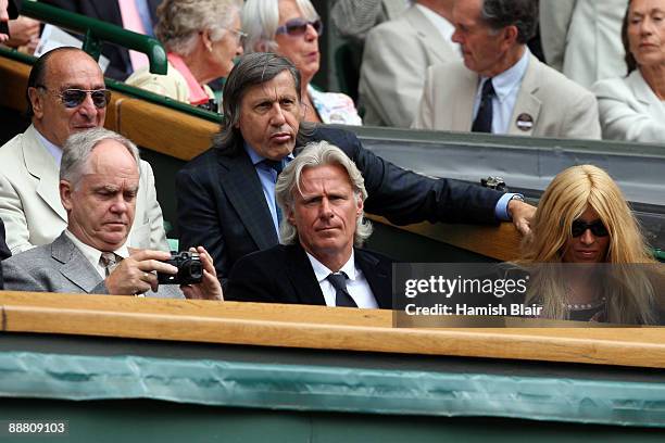 Ilie Nastase , Bjorn Borg and wife his Patricia look on from Centre Court on Day Eleven of the Wimbledon Lawn Tennis Championships at the All England...