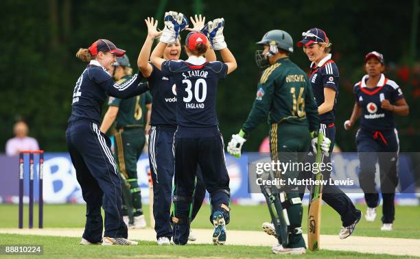 Nicky Shaw of England celebrates with Sarah Taylor, after bowling Shelley Nitschke of Australia for LBW during the Women's One Day International...