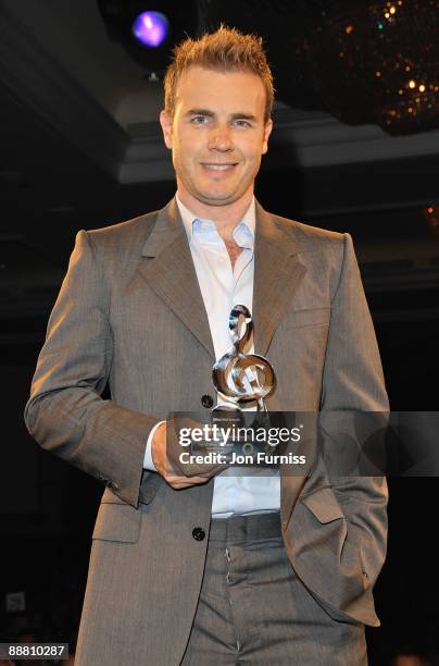 Singer Gary Barlow from Take That with their O2 Silver Clef award during the O2 Silver Clef Awards 2009 at the London Hilton on July 3, 2009 in...