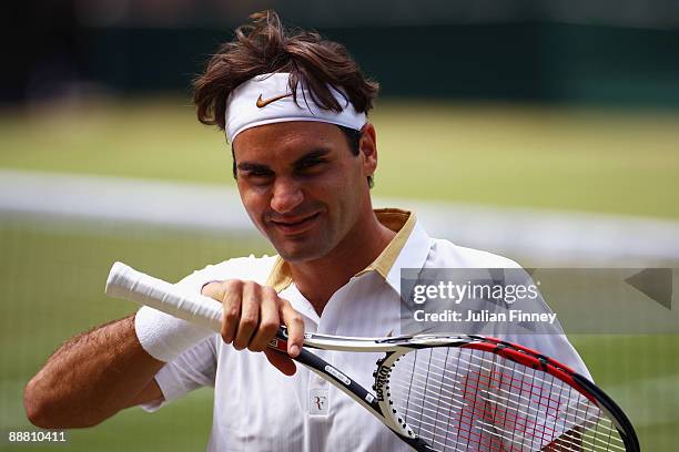 Roger Federer of Switzerland smiles during the men's singles semi final match against Tommy Haas of Germany on Day Eleven of the Wimbledon Lawn...